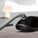 The Miele Complete C3 Kona canister vacuum features a flexible canister hose